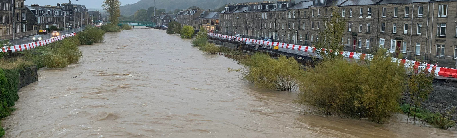 FloodStop Barrier at the side of a river preventing overflowing water entering streets