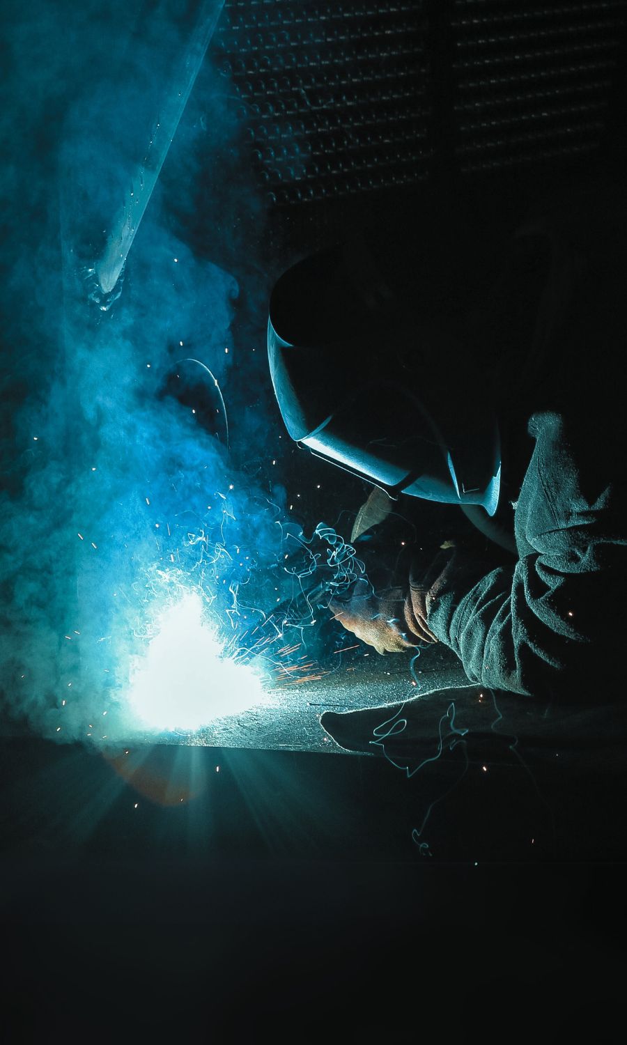 A welder working on a steel unit